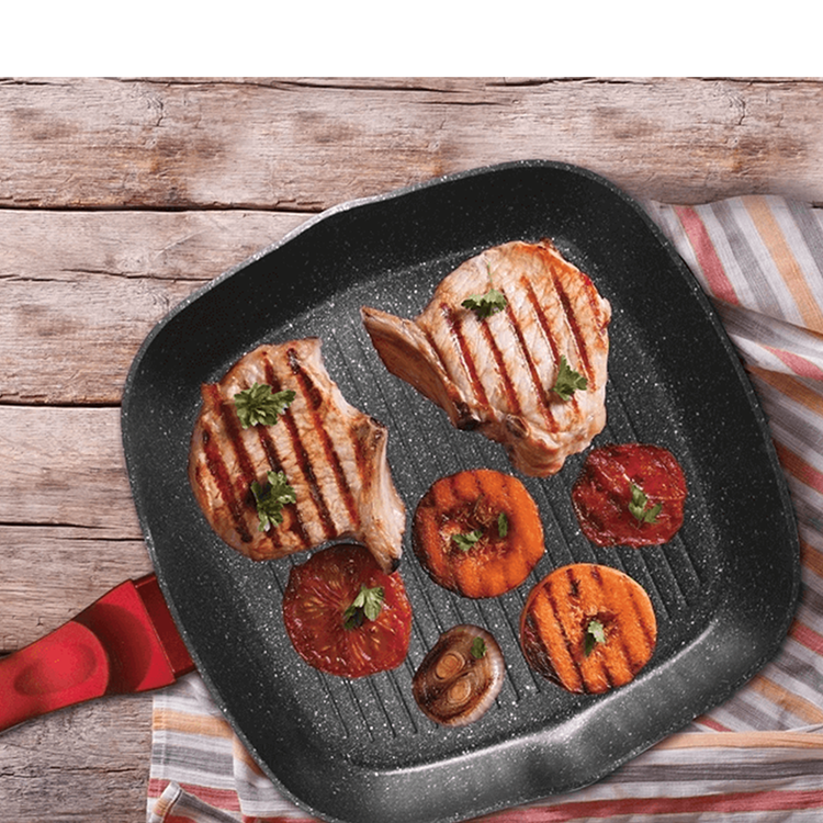 Searing pork chops and vegetables on a grill pan