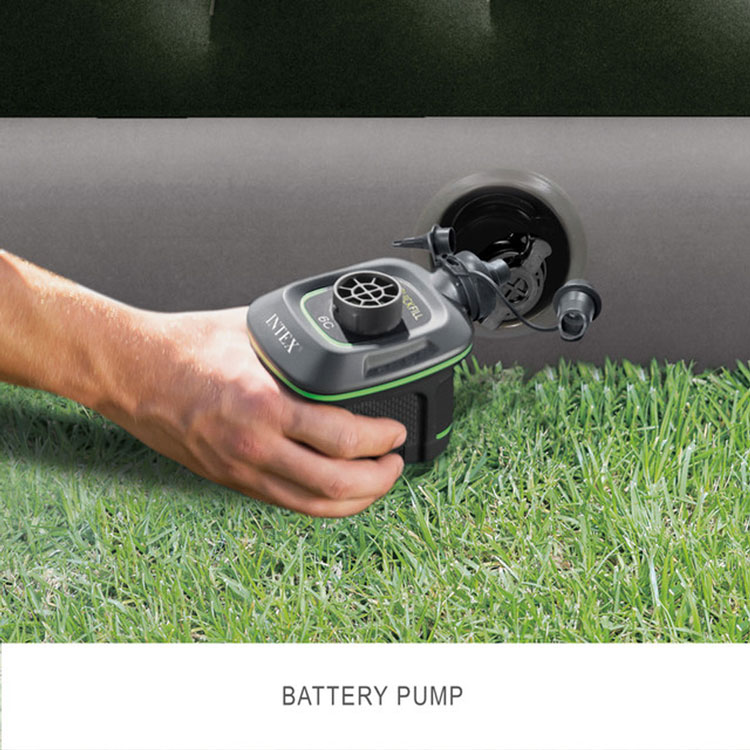 Handheld battery pump inflating an air mattress outdoors
