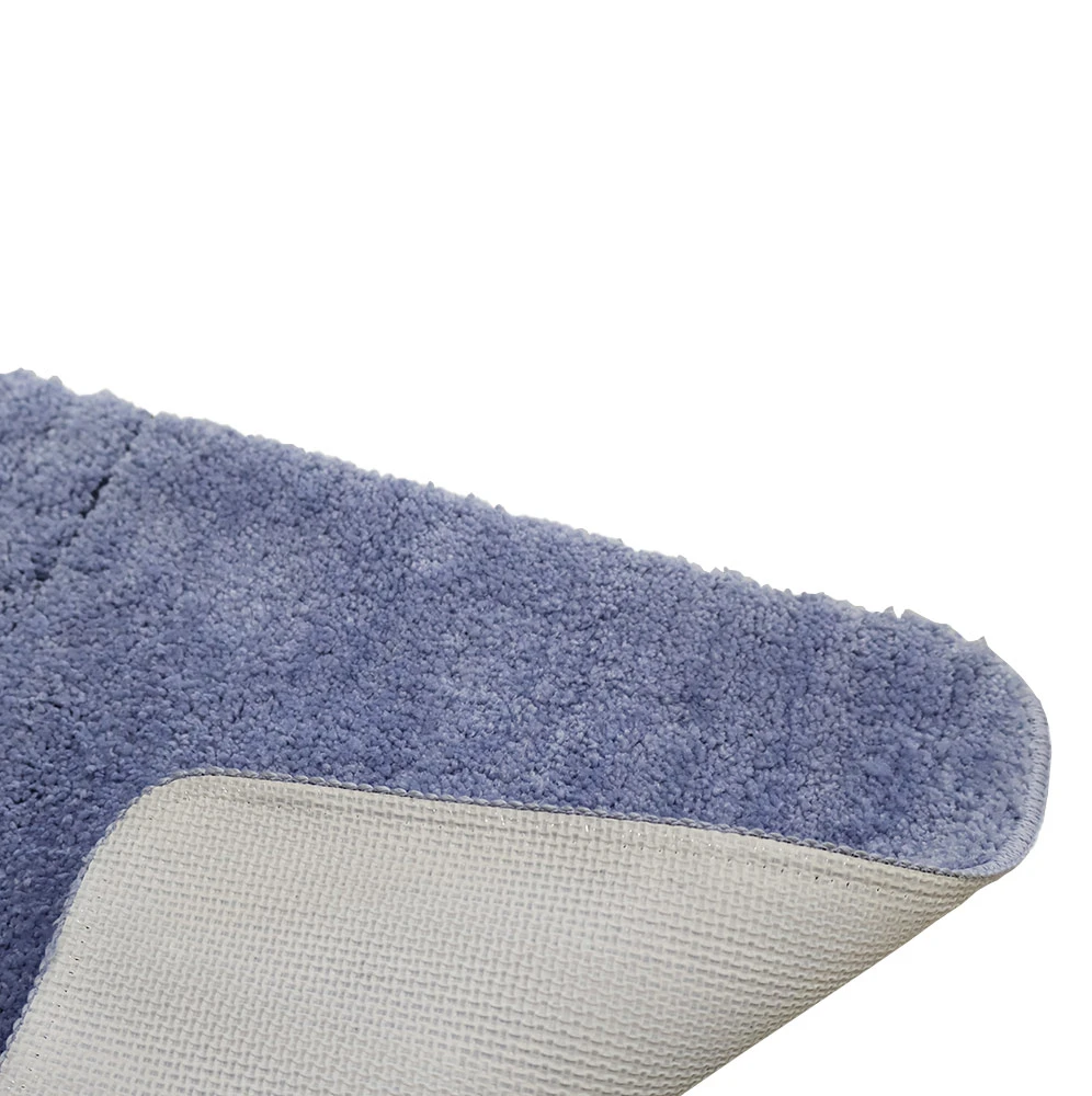 Close-up of the underside of a bath mat, corner folded up