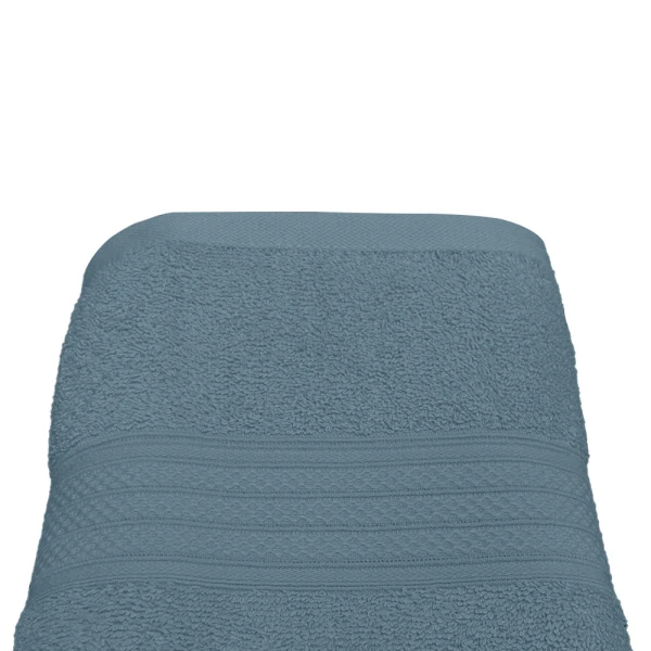 A folded, soft, blue-colored bath towel.