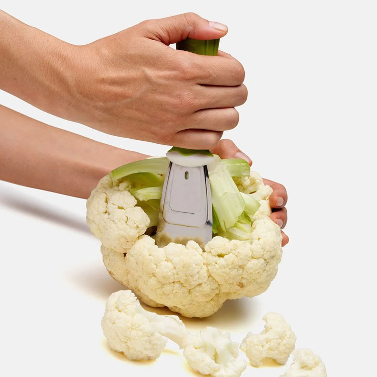 Hands using Chef'n StalkChop on cauliflower.