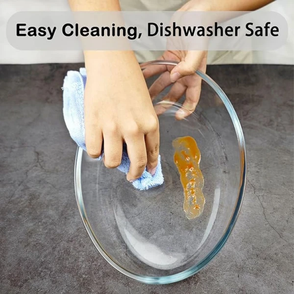 Wiping clean an oval glass bakeware dish.