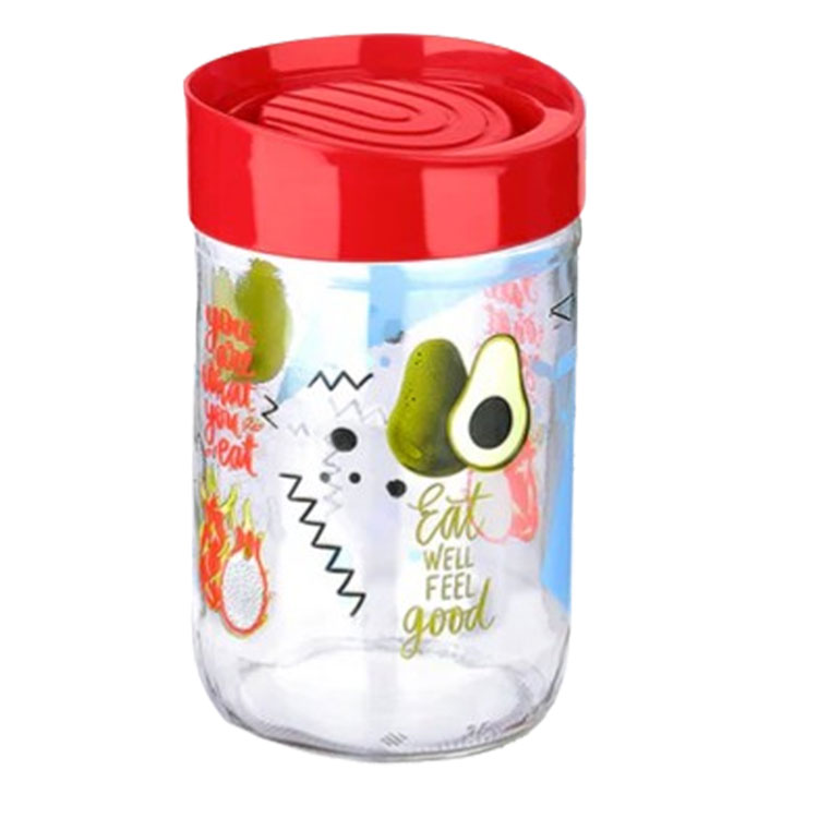 A glass storage jar with a red lid.