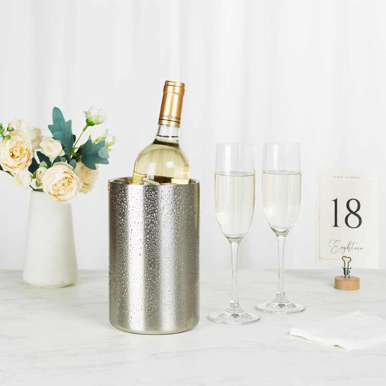 Stainless steel wine cooler with champagne glasses.
