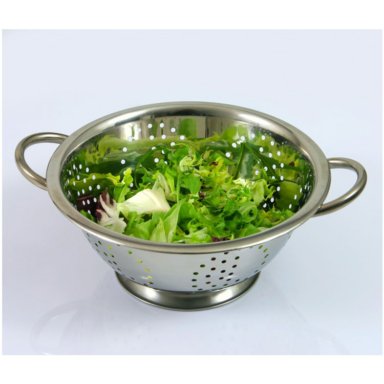 Stainless steel colander with fresh salad greens.