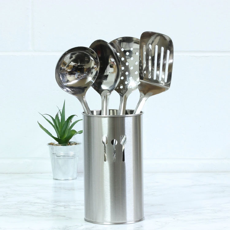 Stainless steel utensil holder with kitchen tools.