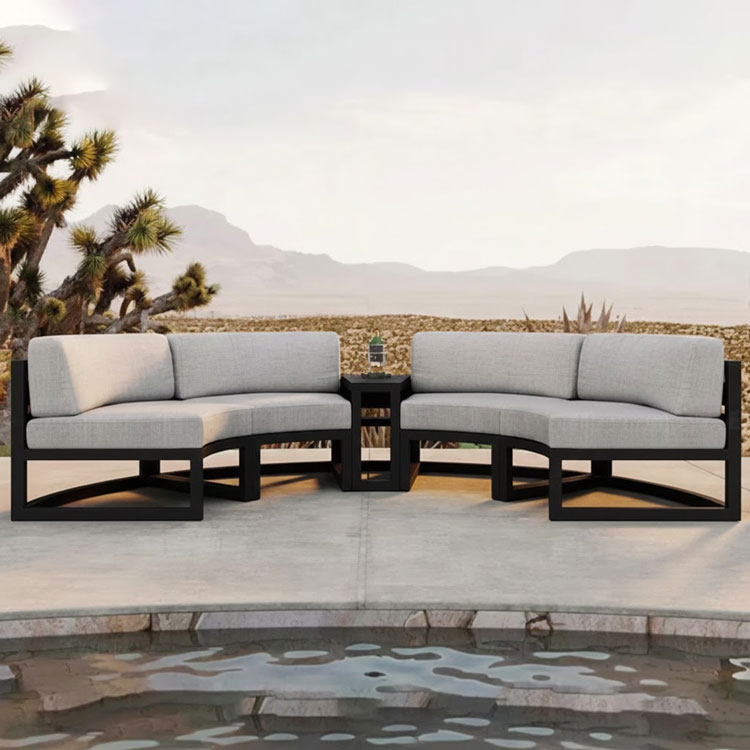 Four curved outdoor sofas with two triangular tables.