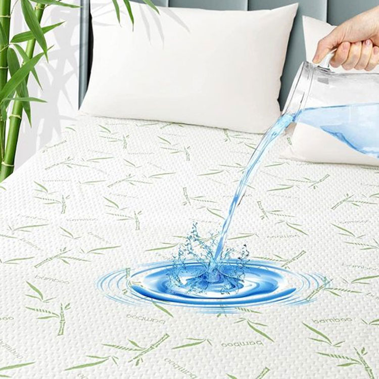 Water pouring onto a waterproof bamboo mattress protector.