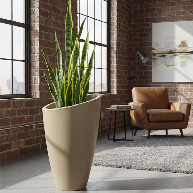 Large beige Eden planter with indoor snake plant.