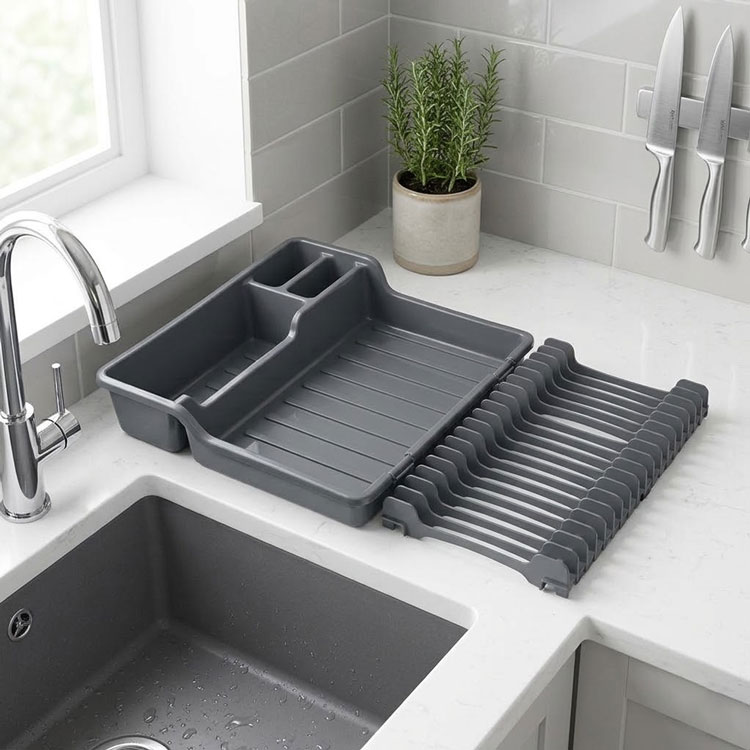 Modern grey expandable dish rack on white countertop.