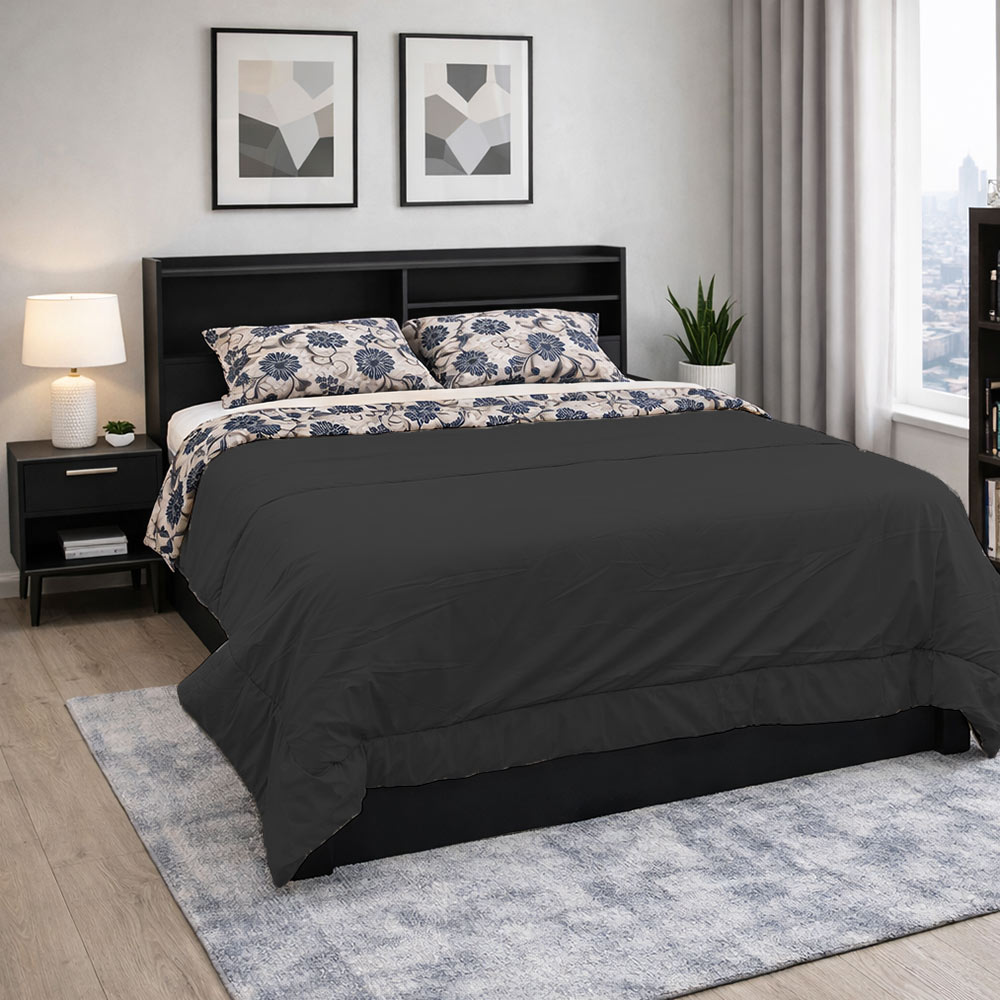 Reversible black comforter set on modern platform bed.