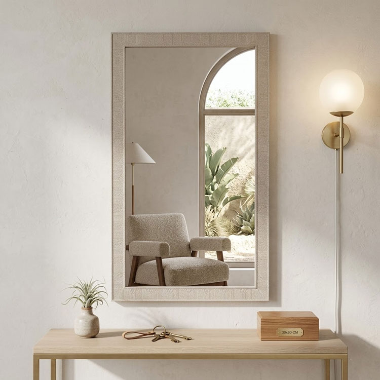 Modern light grey mirror above wooden console table.