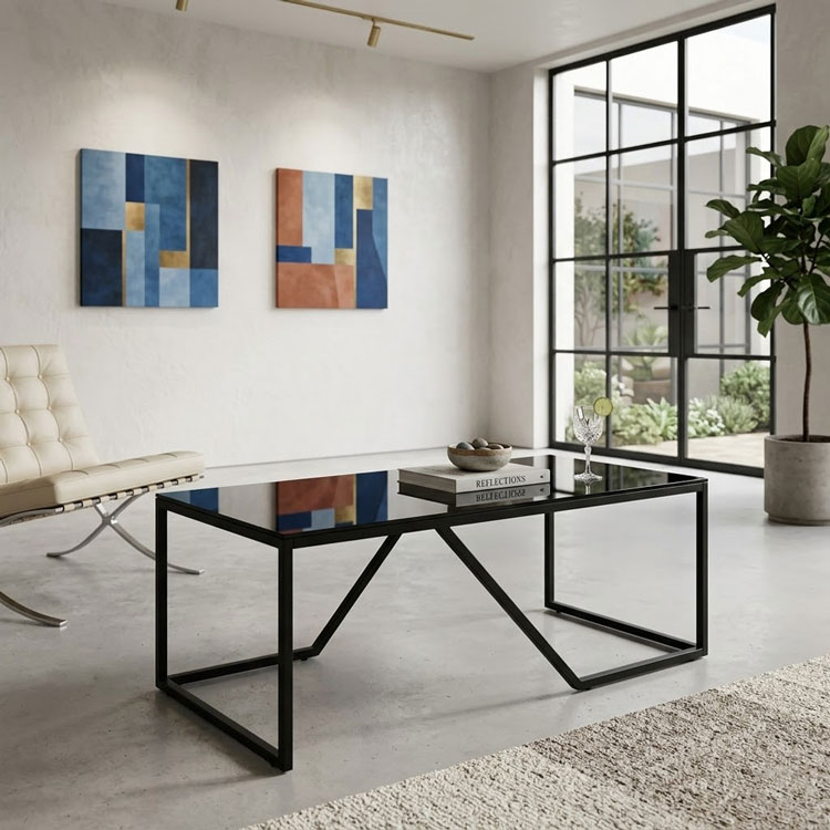 Rectangular black glass coffee table in bright room.