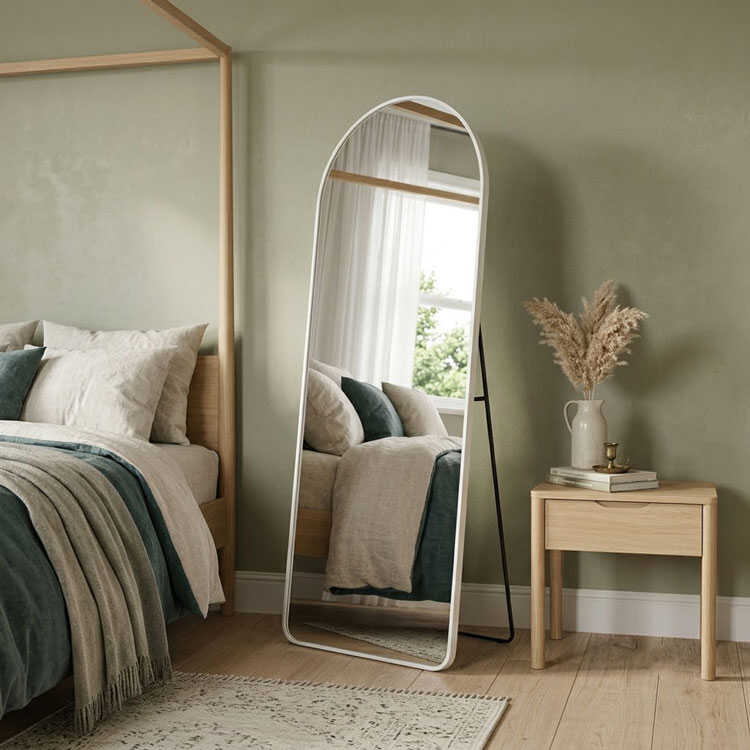 White full length mirror next to nightstand table